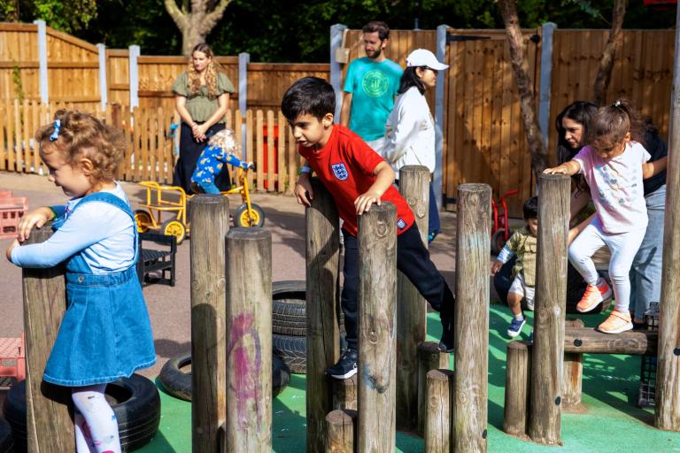 Image of young children playing on a soft play area